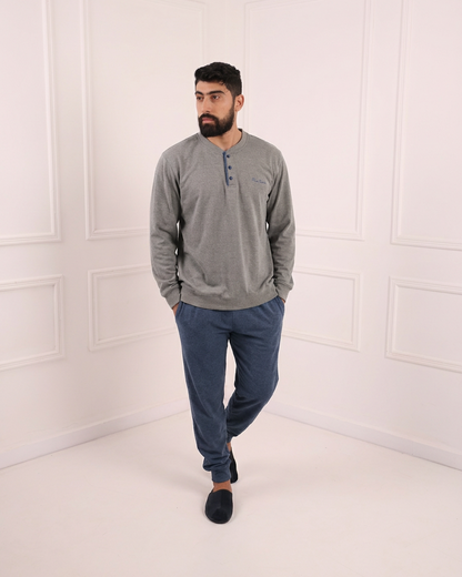 Pyjama homme gris clair et bleu marine porté par un mannequin en studio blanc – tenue de nuit élégante et confortable